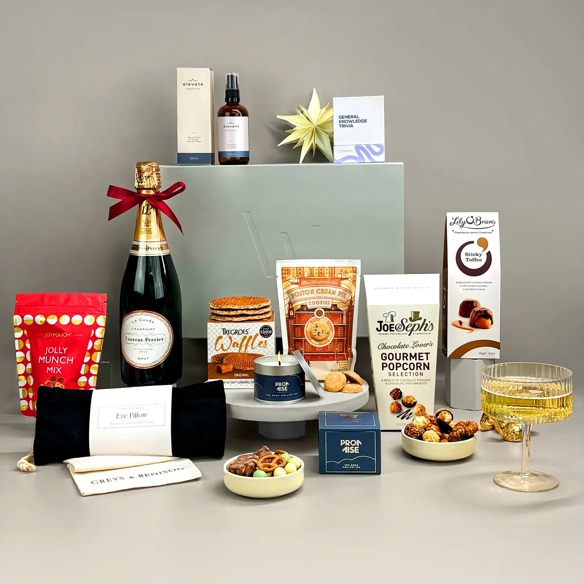 Deluxe Luxury Gift including champagne, sweet and savoury food treats, wellness items and a charitable donation.