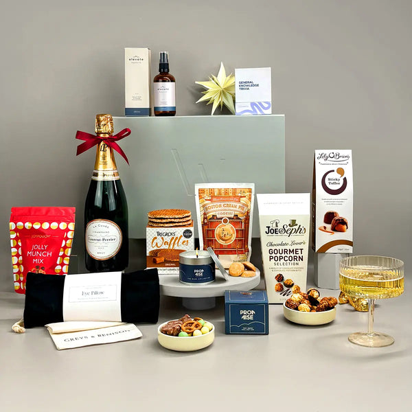 Deluxe Luxury Gift including champagne, sweet and savoury food treats, wellness items and a charitable donation.
