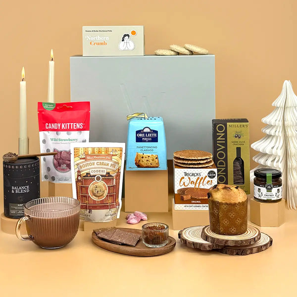 Corporate Christmas Hamper of festive food and drinks, including hot chocolate, sweet treats, savoury snacks and a charitable meal donation.