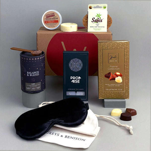 Sleep and Rest aid gift. Collection of items including a sleep mask, candles, and chocolate.