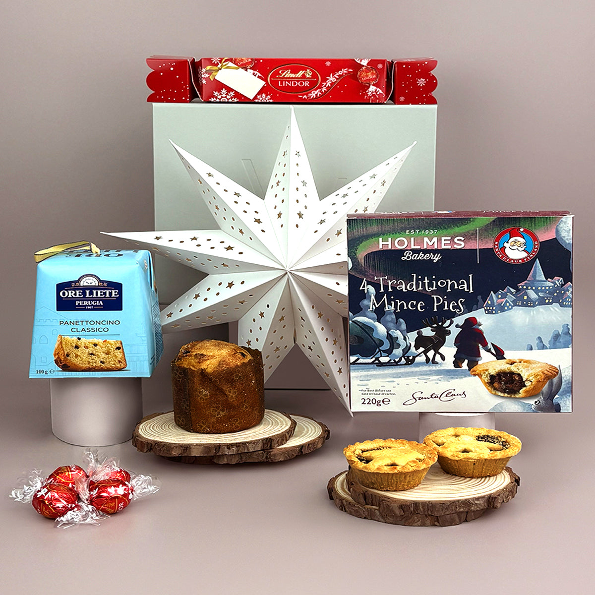 the perfect small corporate christmas gift of festive food includes Lindt chocolate, panettone and mince pies. 