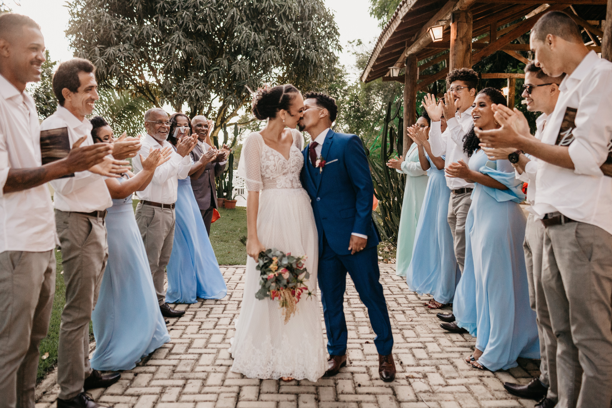 Wedding couple kissing in front of guests